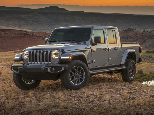 a 2020 silver jeep gladiator rubicon parked in a desert terrain