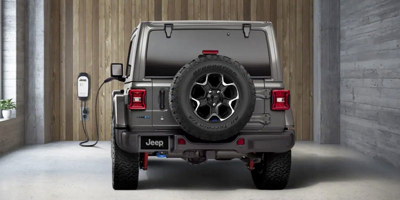 An electric car parked in a shaded garage