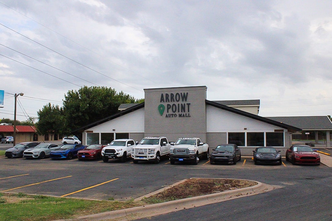 lineup of used vehicles in front of a dealership