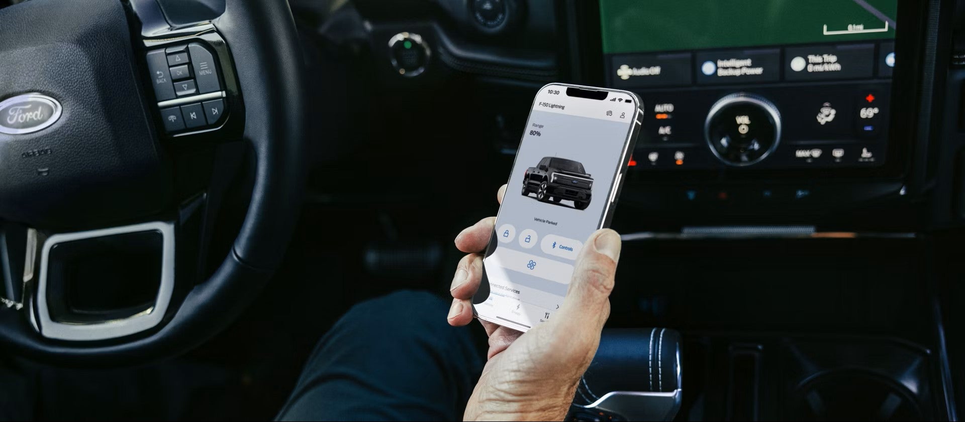 A driver using a smartphone app to start an EV