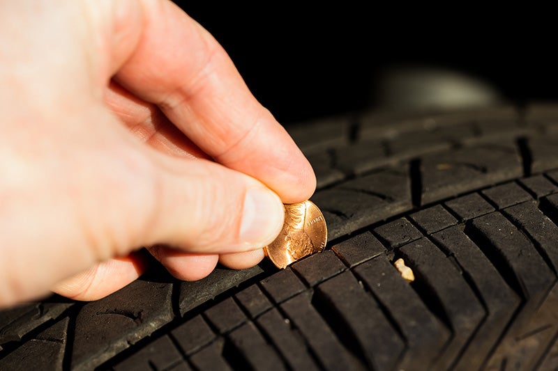 checking the tire tread with a penny